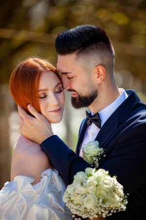 A romantic wedding photoshoot sequence shows tender moments between newlyweds with a white bouquet and outdoor autumn setting.