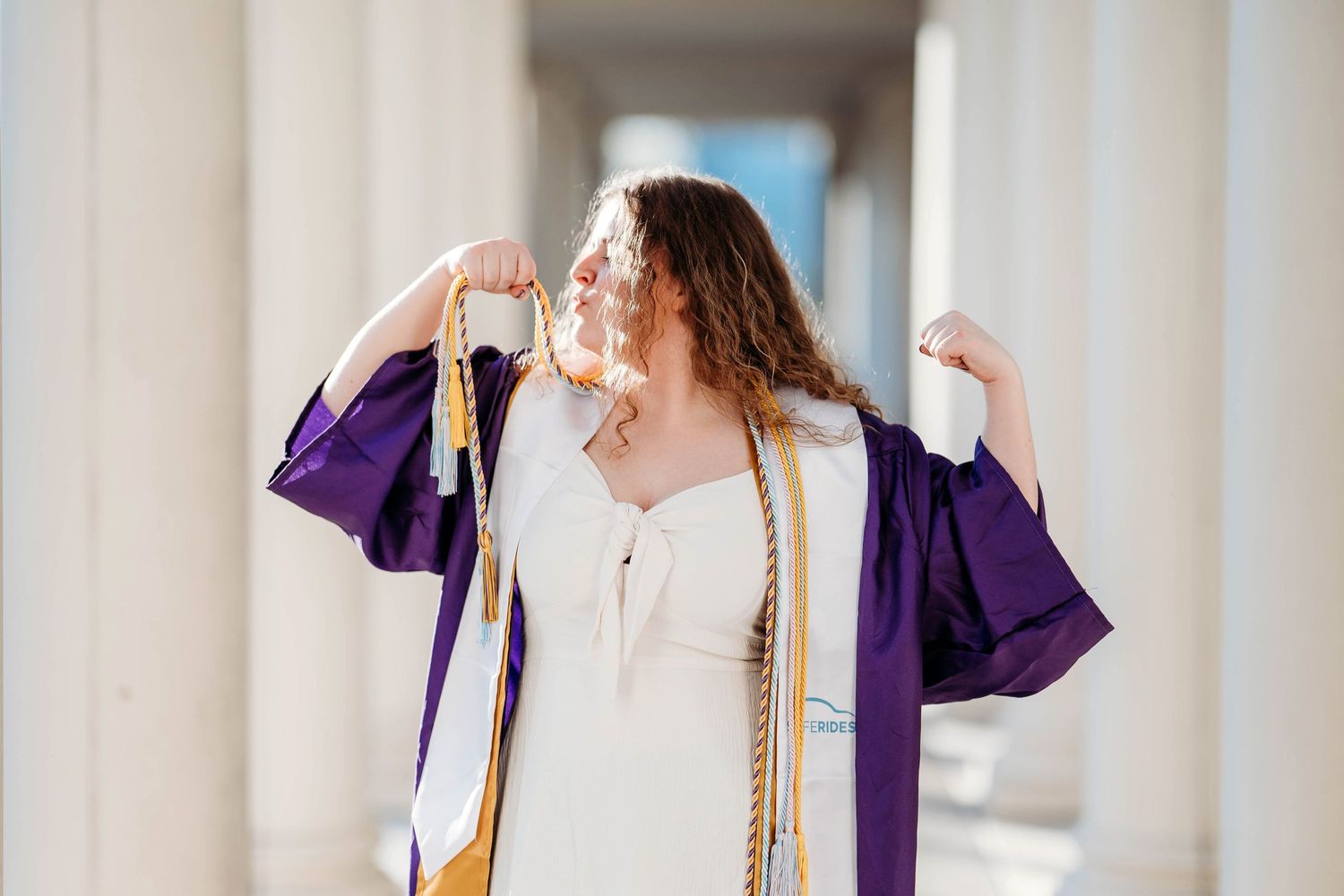 A graduation celebration sequence shows a person in royal blue cap and gown dancing joyfully in front of a white building.
