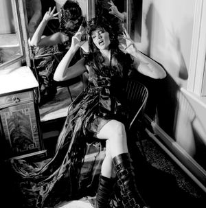 Black and white photograph showing Jessica Wilcock wearing a head dress by Heather Shaw and a black outfit by Shein
