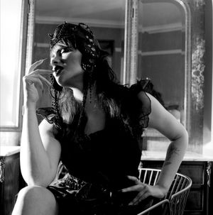 Black and white photograph showing Jessica Wilcock wearing a head dress by Heather Shaw and a black outfit by Shein