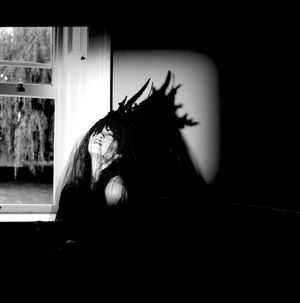 Black & white photograph showing Jessica Wilcock wearing a headdress by Jay Briggs Millinery.