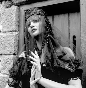 Black and white photograph showing Jessica Wilcock wearing a head dress by Heather Shaw