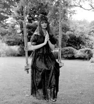 Black and white photograph showing Jessica Wilcock wearing a head dress by Heather Shaw