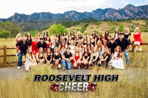 Group of cheerleaders pose together in front of scenic Colorado mountain landscape with Flatirons visible in background.