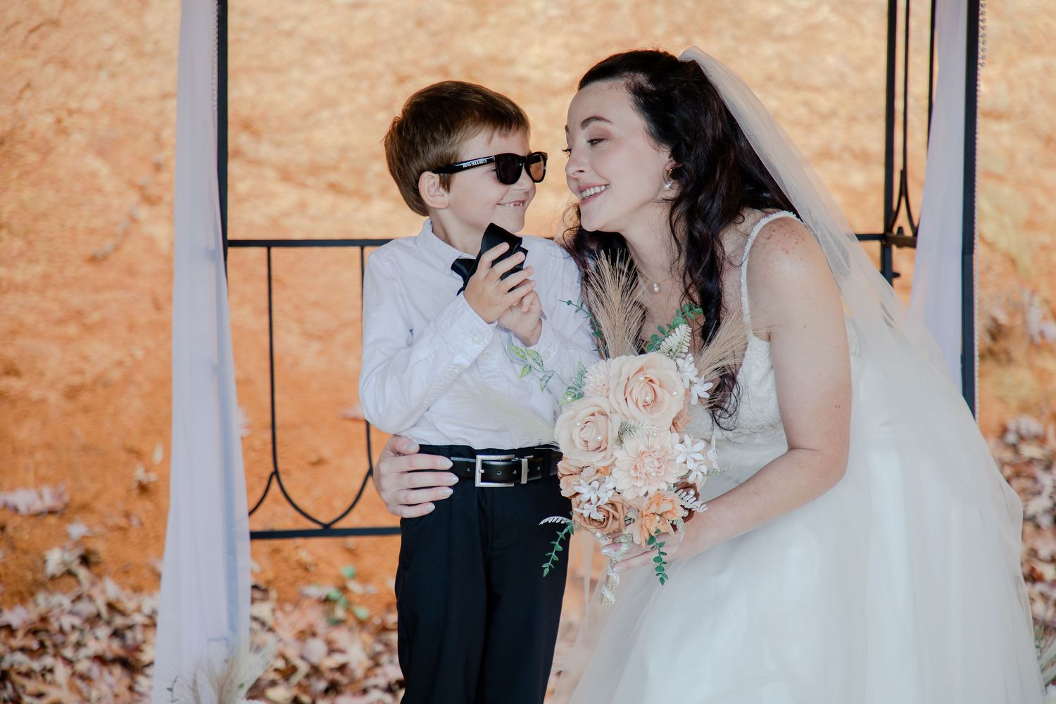 A romantic outdoor wedding photo sequence showing tender moments between a couple against a warm peach-colored backdrop.