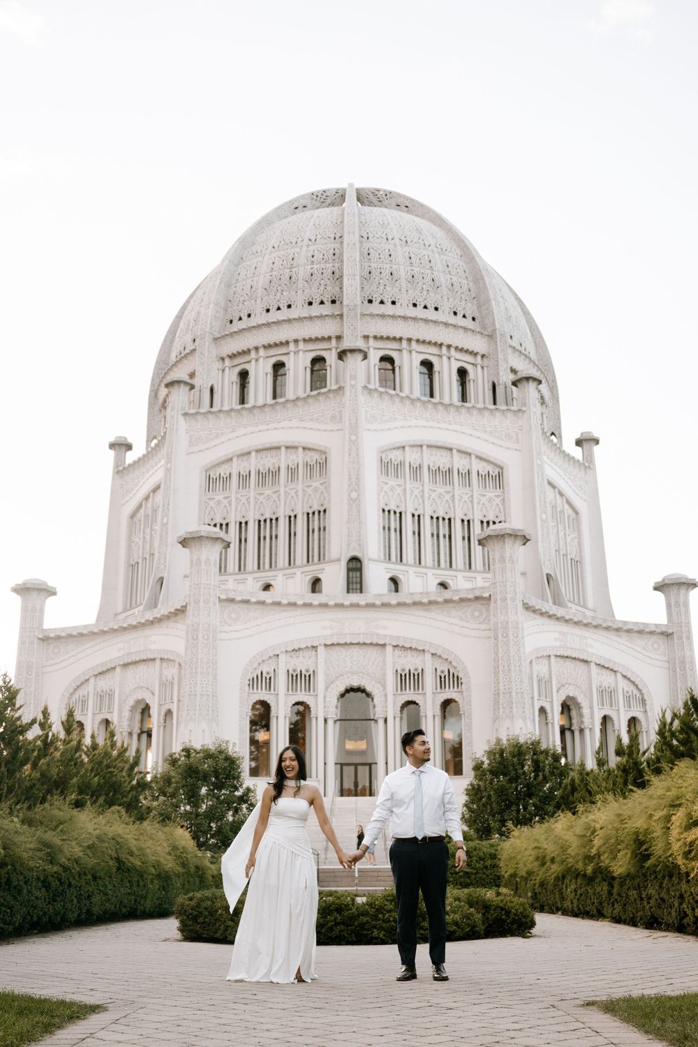 Wedding couple seen in multiple artistic angles against the majestic white domed Bahai Temple in Chicago.