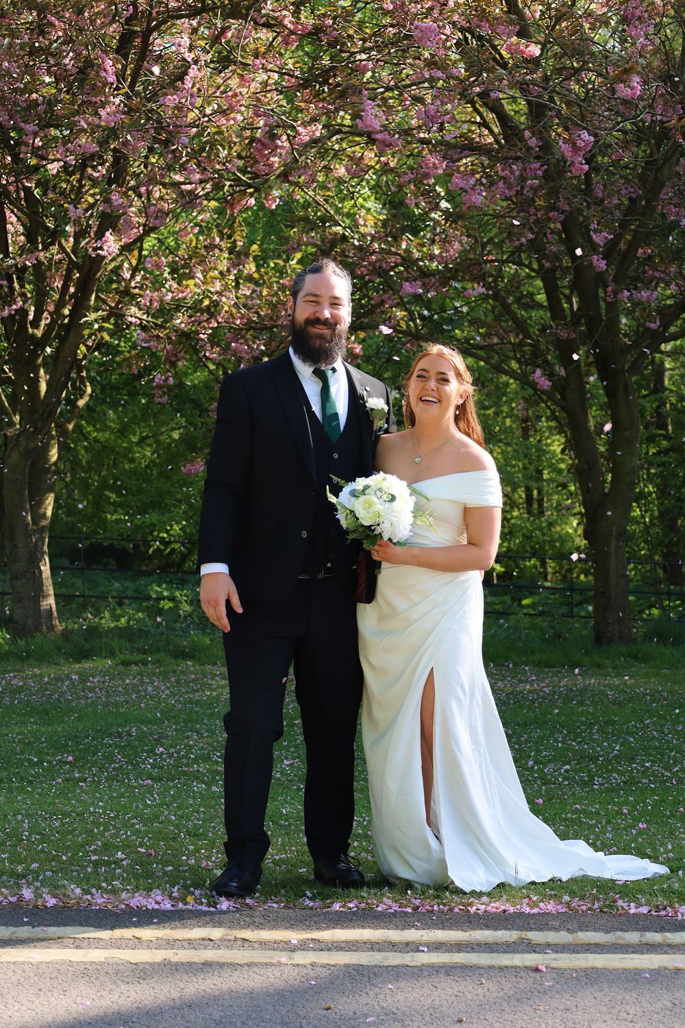 Wedding celebration under blooming cherry trees in spring.