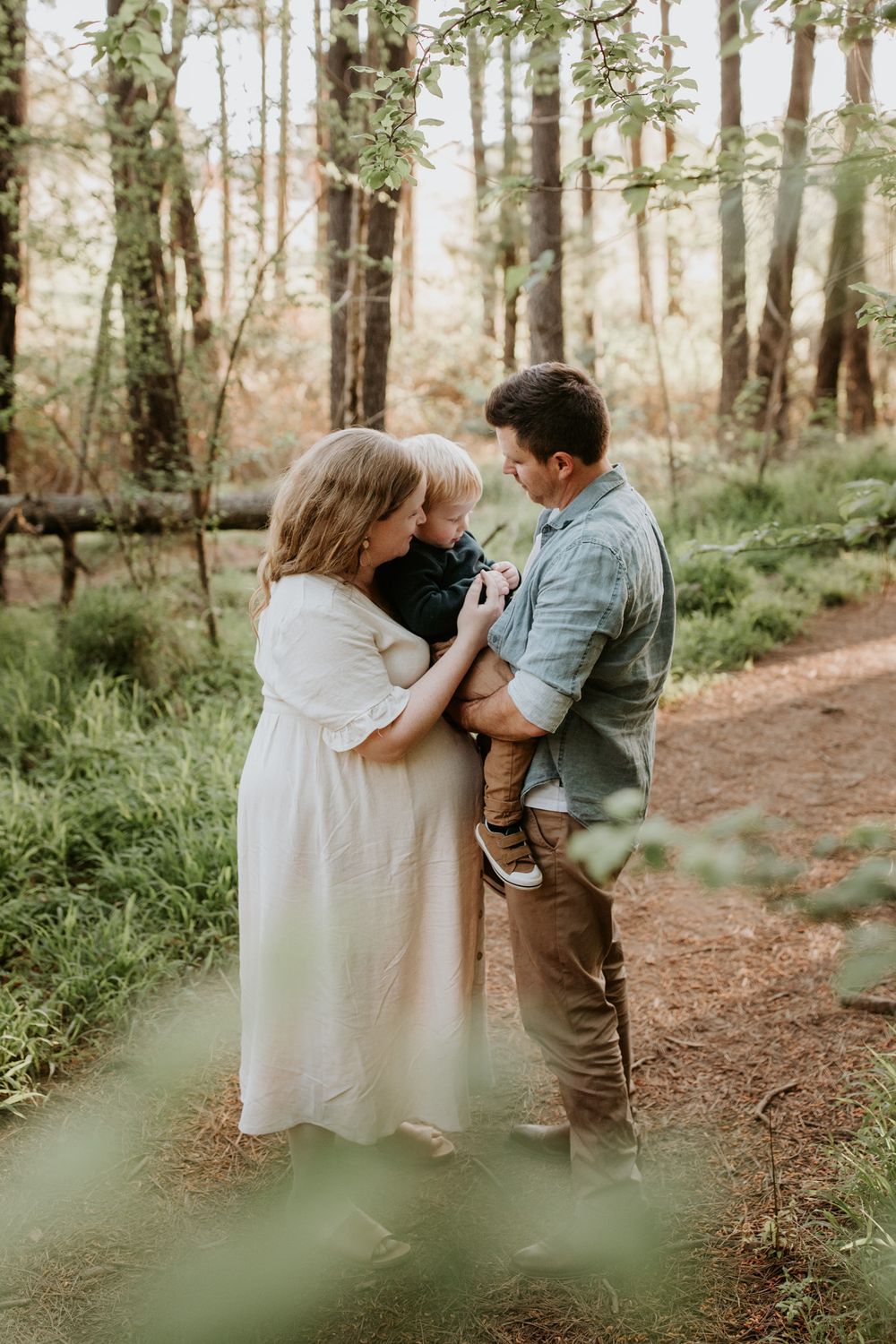 Adelaide family photographer Lauren Lunn, captures an expecting family snuggling under a forest canopy before their next baby arrives.