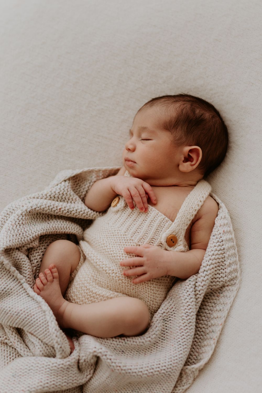 Sleeping newborn wrapped in neutral blankets during Adelaide photo session with Lauren Lunn Photography.
