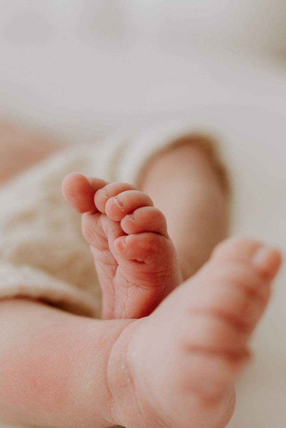 Baby wriggles toes during Adelaide newborn photo session with Lauren Lunn in Tea Tree Gully studio.