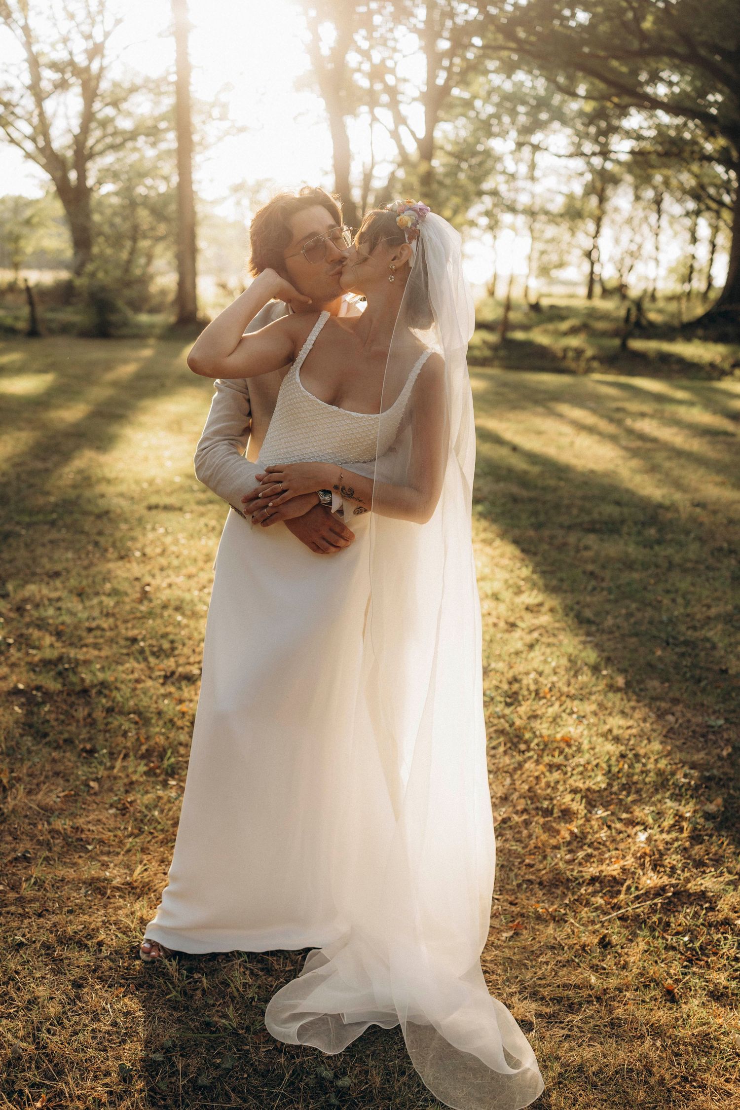 A tender autumn embrace captured during a wedding photoshoot with fall foliage.