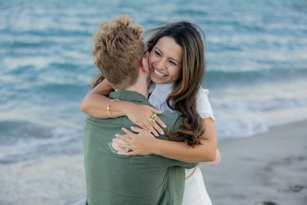 girl hugging fiancé after engagement at Hollywood North beach park