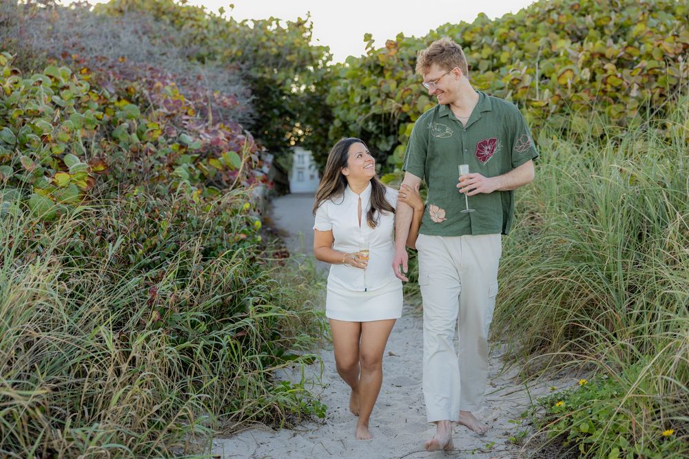 couple with champagne walking out of mangroves at Hollywood North beach park