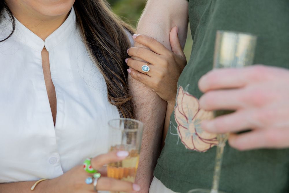 ring shot with champagne glass after engagement at Hollywood North beach park