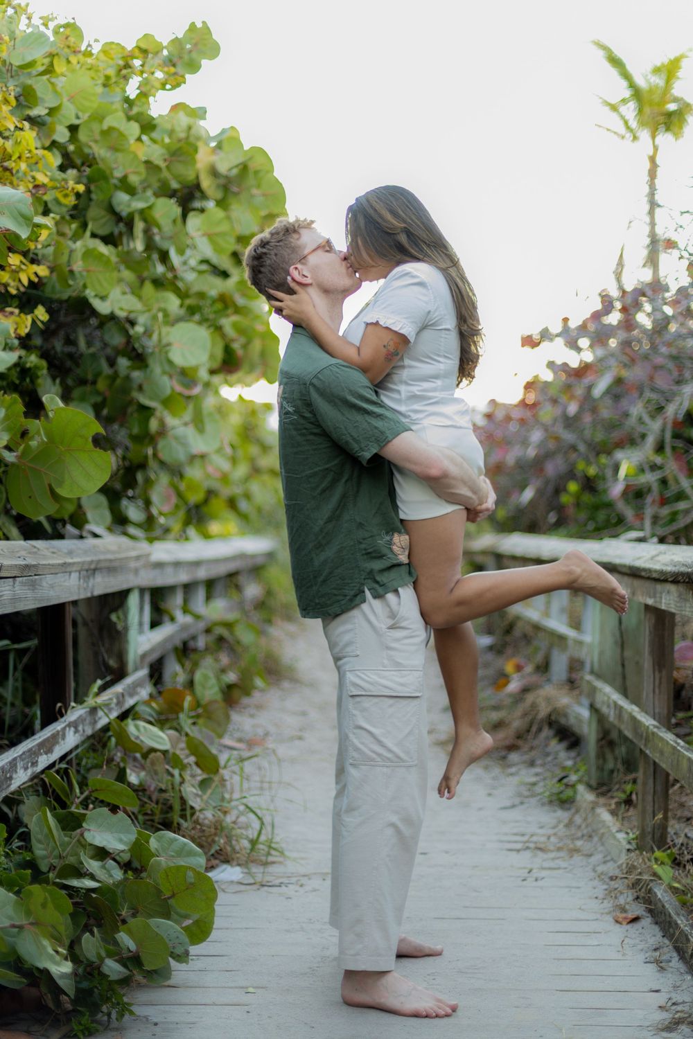 couple kissing with guy lifting girl at Hollywood North beach park