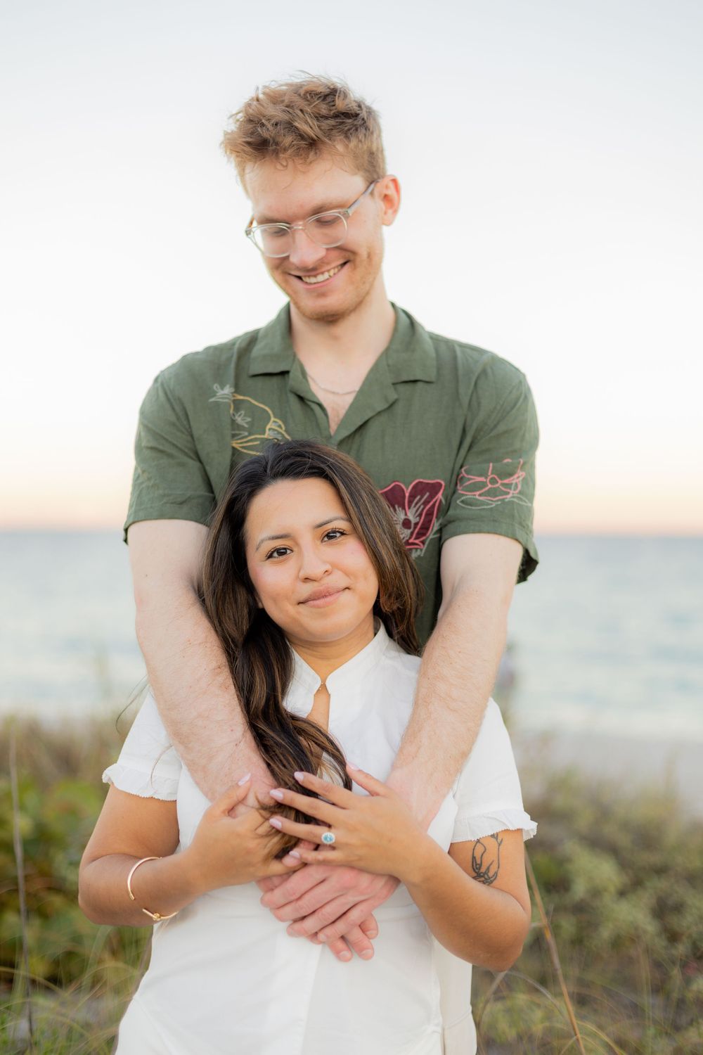 couple embracing during engagement shoot at Hollywood North beach park