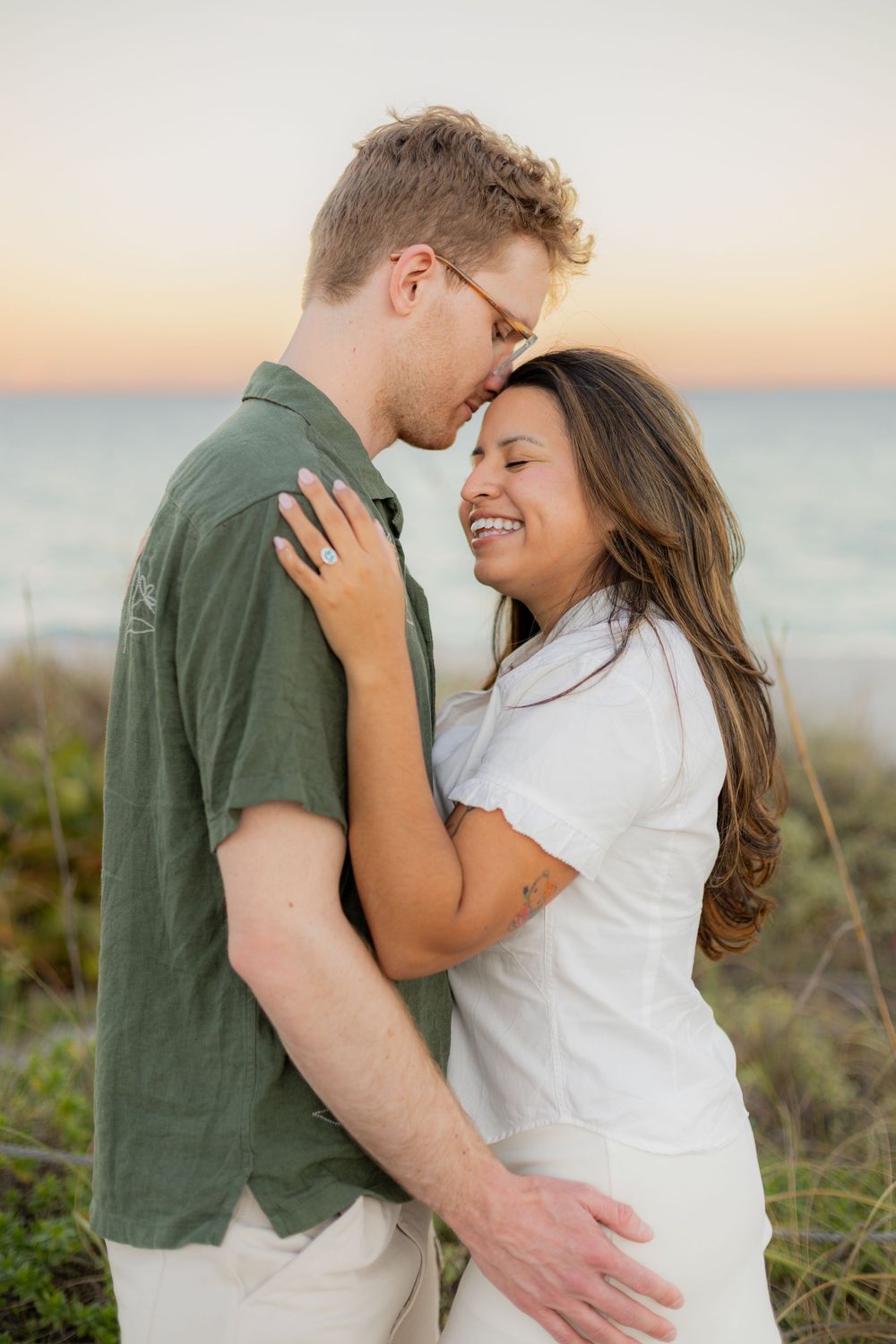 guy kissing his Girl during engagement shoot at Hollywood North beach park
