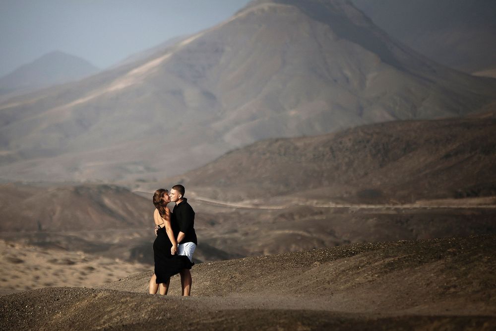 Couple sharing a quiet moment in the vast desert landscape of La Pared - Romantic Fuerteventura portraits