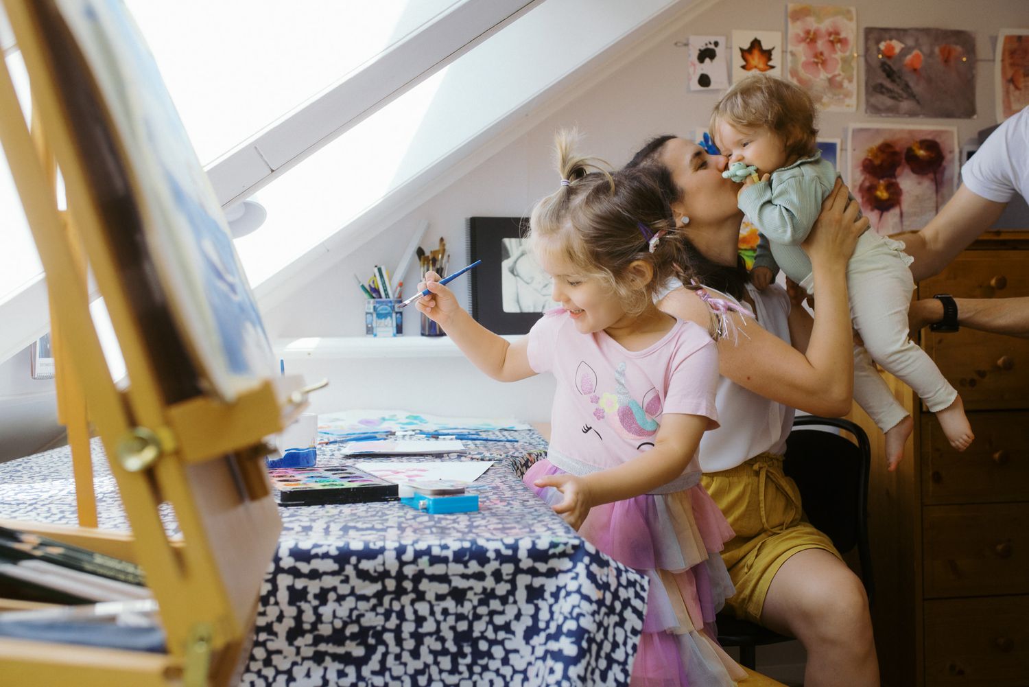 Children play with colorful educational toys and learning materials while sitting on the floor in a classroom setting.