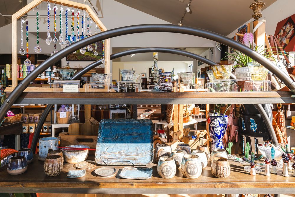 Panoramic view inside a rustic country store showing wooden shelves stocked with merchandise and vintage decor.