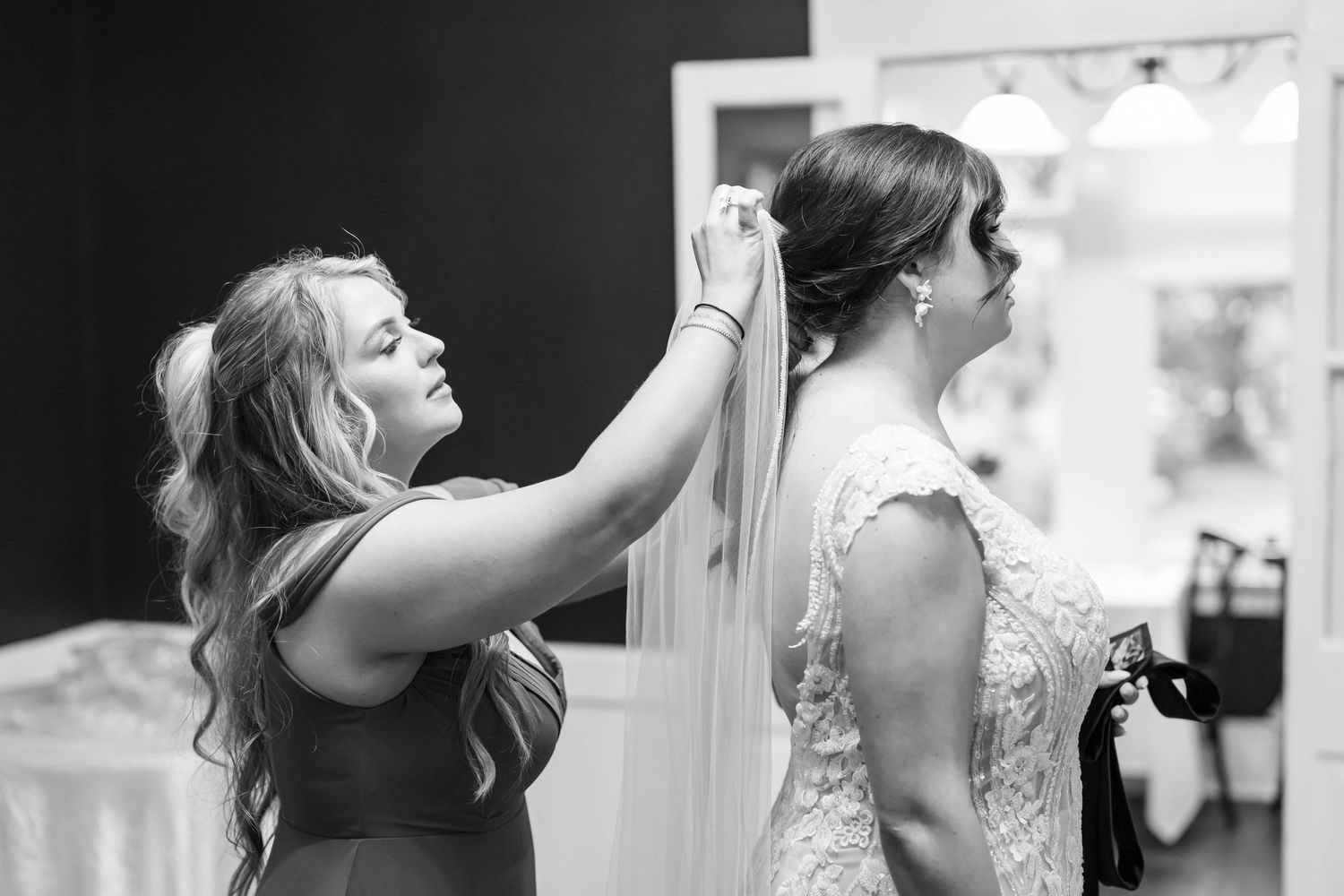 bride with mom placing veil