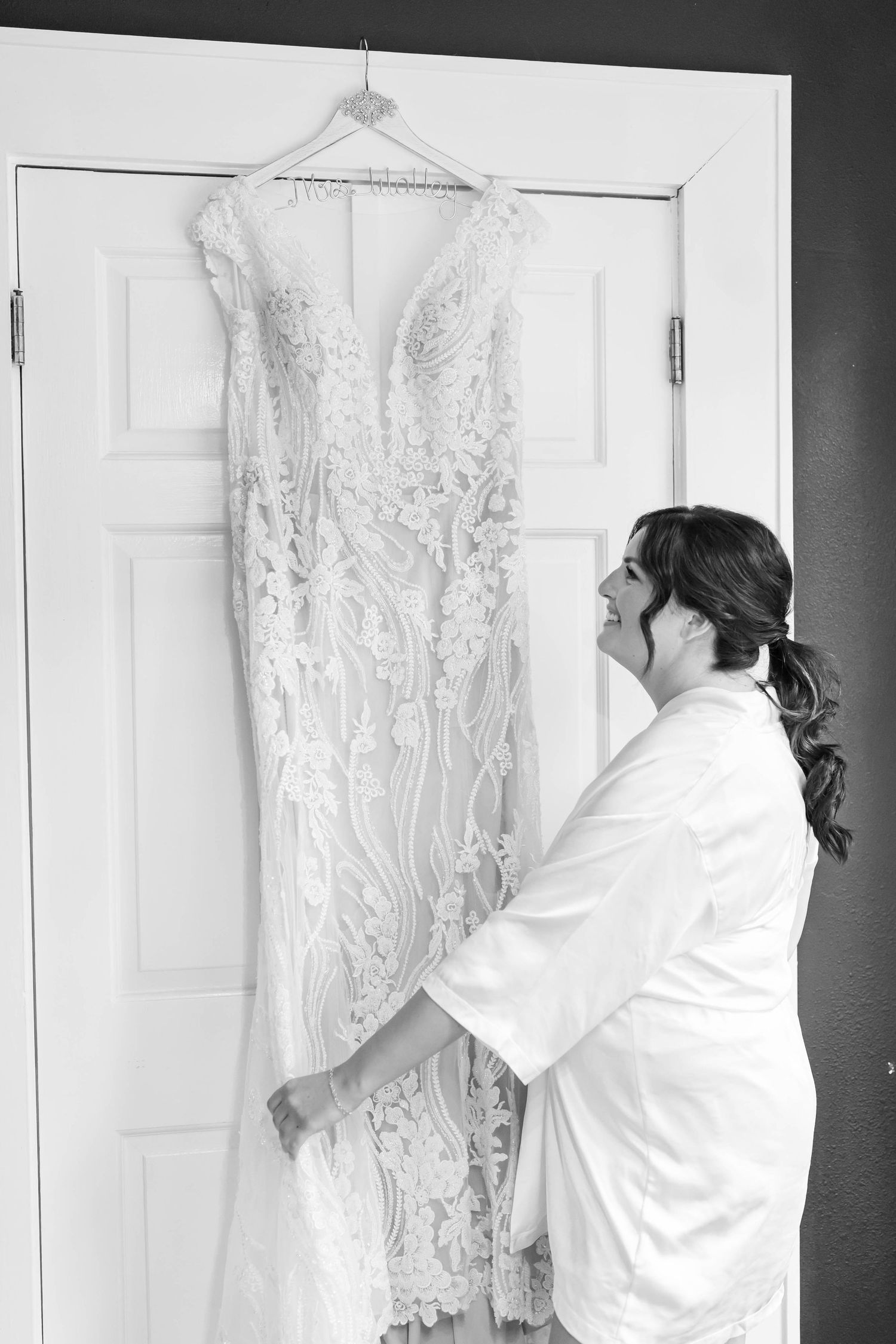 bride looking at dress