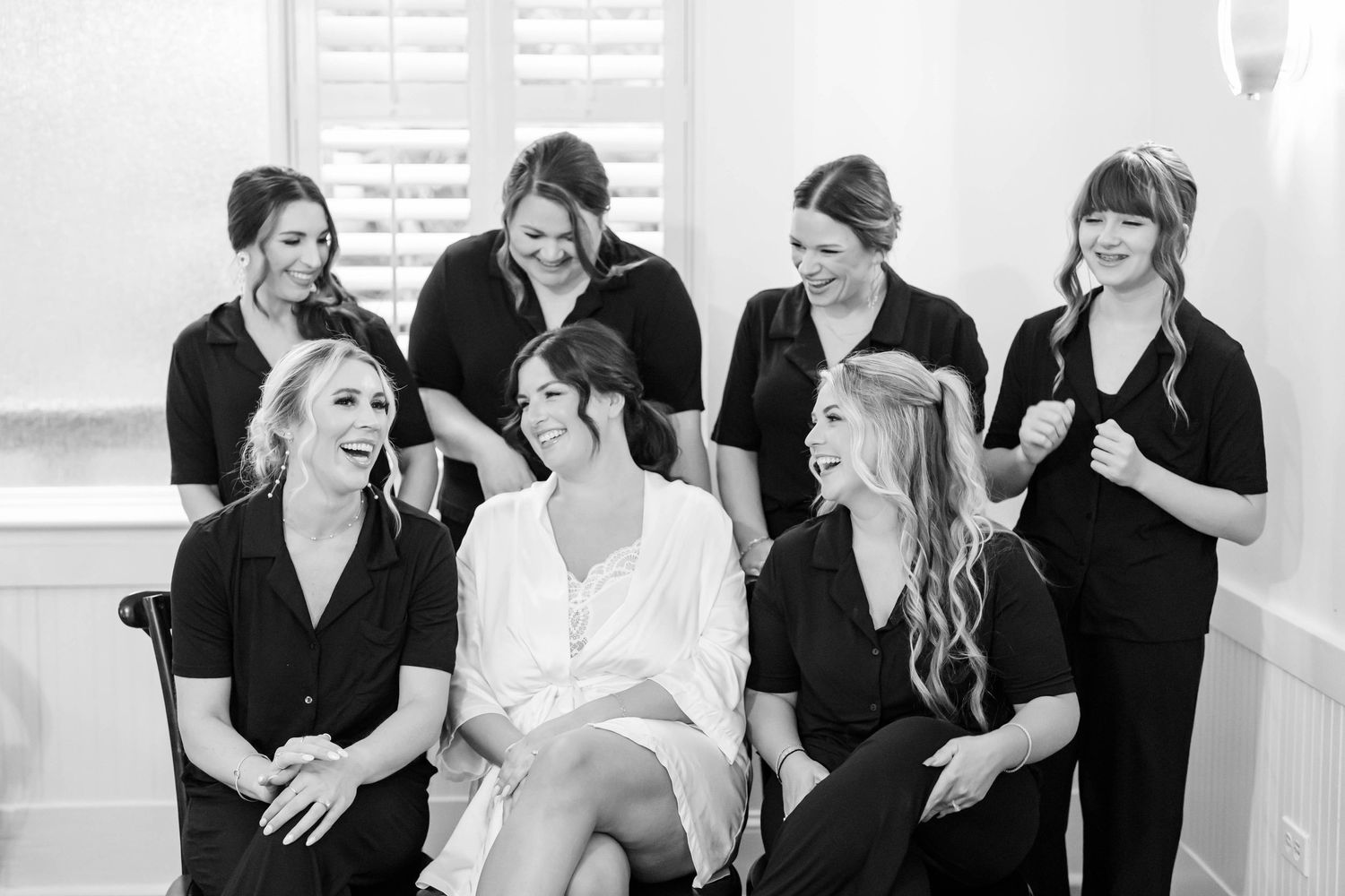 bride laughing and getting ready with bridesmaids