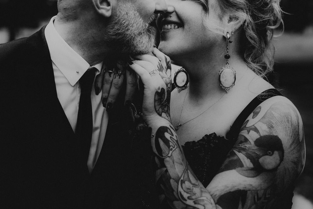Close-up black and white photo of two people sharing an intimate moment.