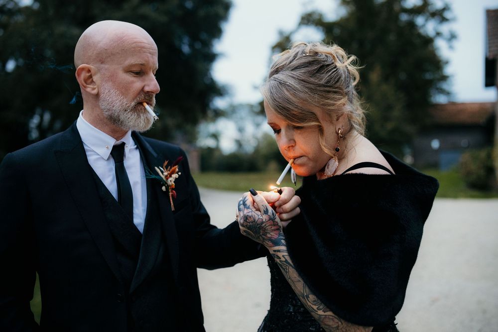 Romantic outdoor wedding scene with couple holding hands and walking together in formal attire.