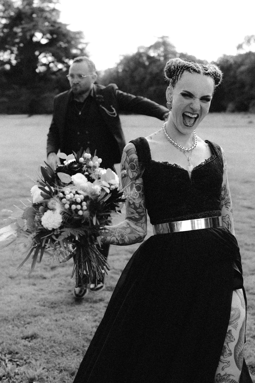 A couple in black wedding attire share joyful moments together in a series of candid outdoor photos.