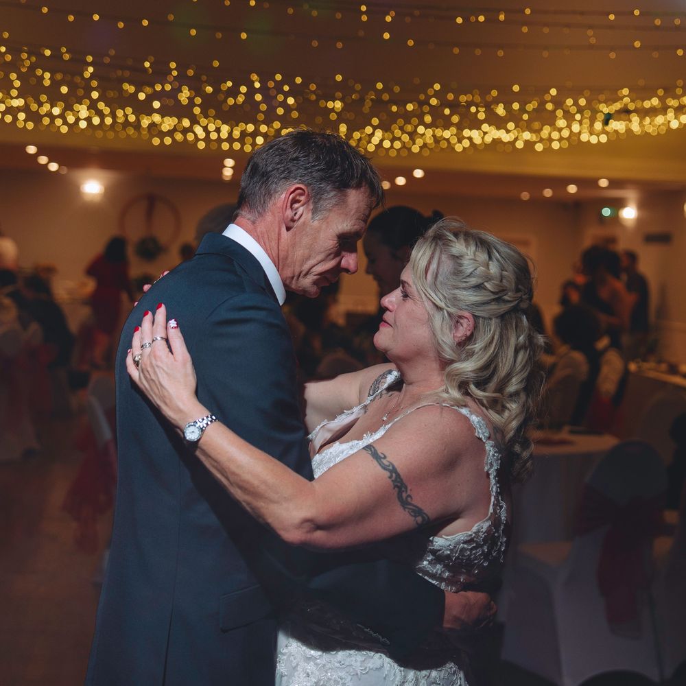 A sequence of romantic dance moments at a wedding reception under warm glowing lights.