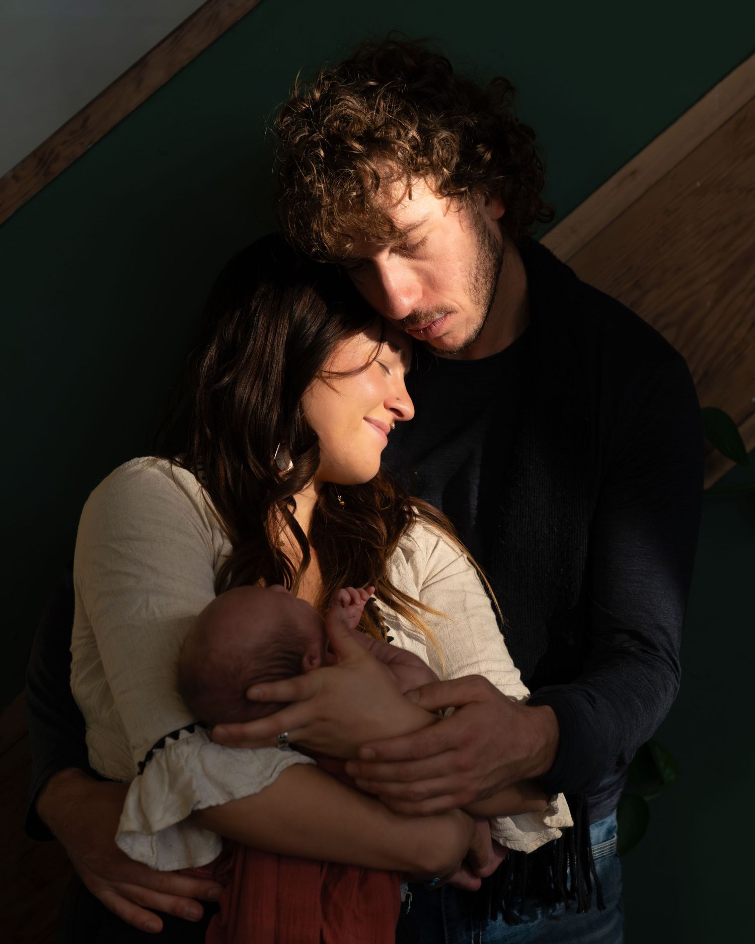 Intimate low-light portrait session featuring soft shadows and dramatic lighting.