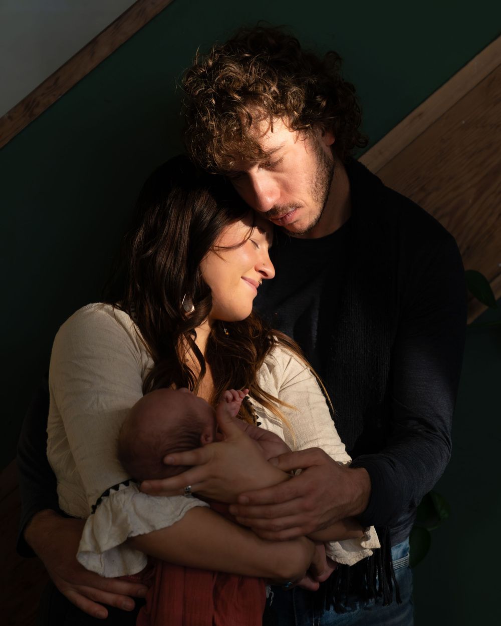 Intimate low-light portrait session featuring soft shadows and dramatic lighting.