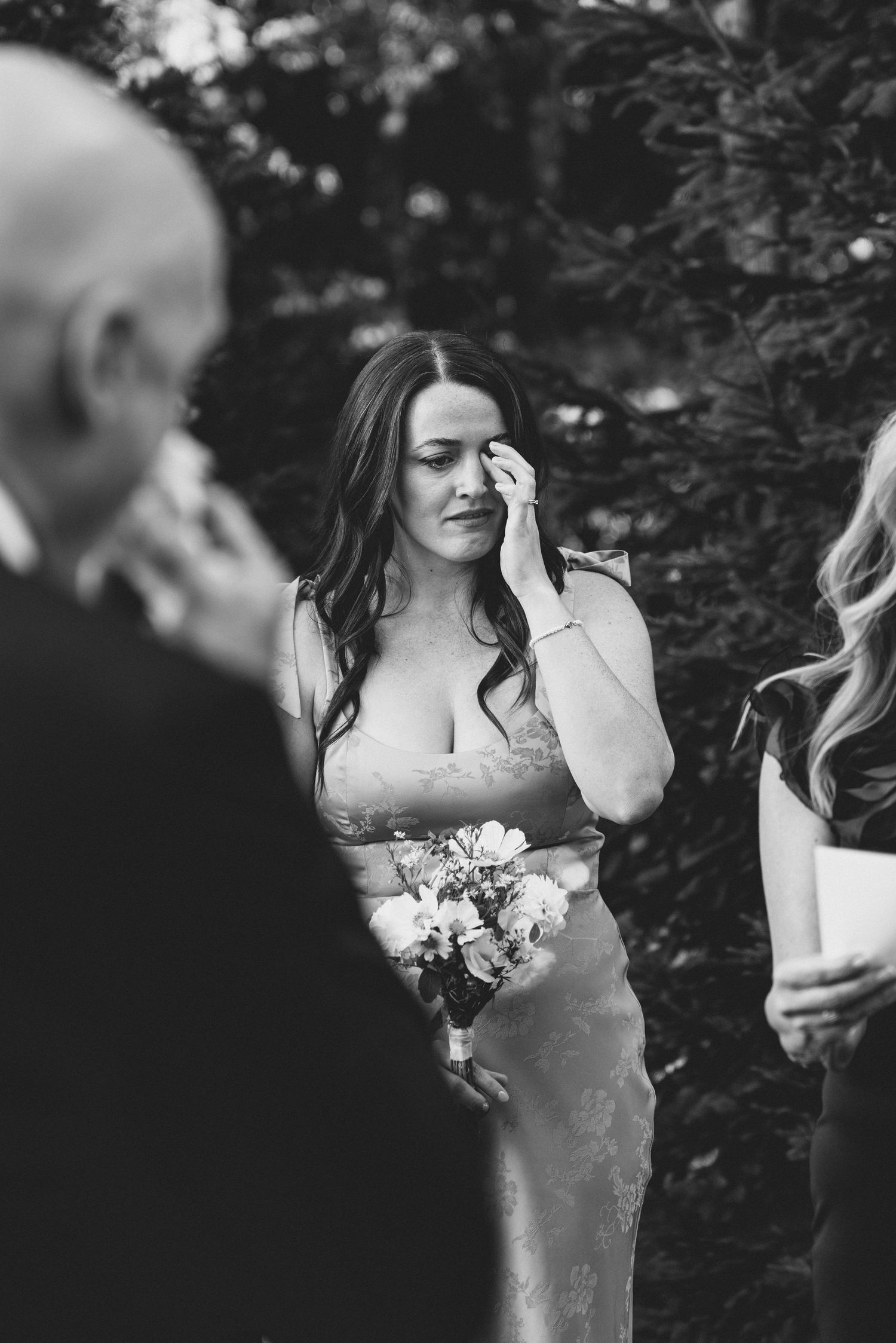 Black and white candid wedding photos show bride and groom sharing intimate moments in a garden setting.