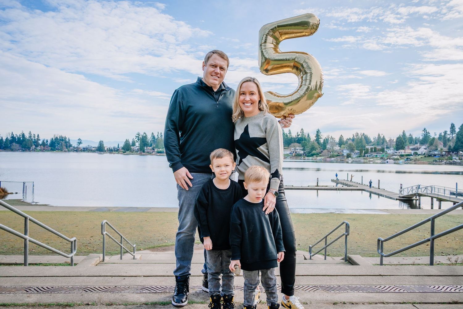 Family standing near the lake during outdoor photos at Angel Lake Park