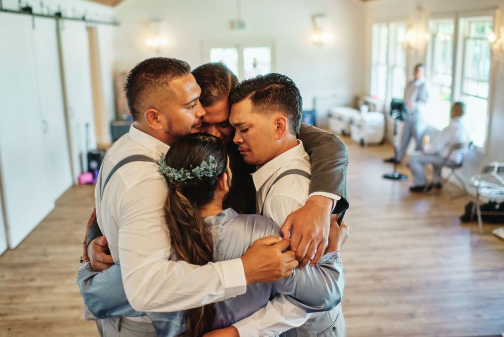 Intimate wedding moments shared on a light wooden dance floor.