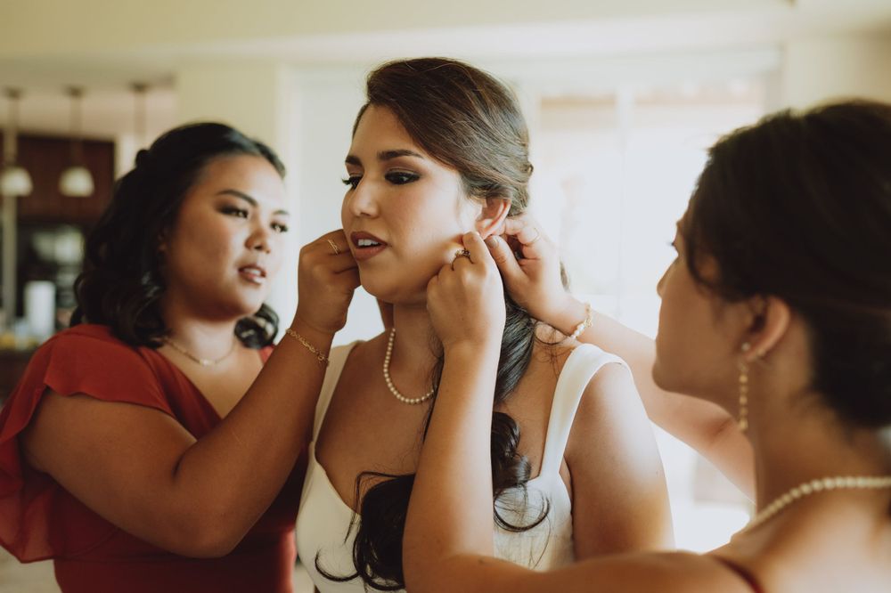 Candid moments captured during wedding day preparation with warm lighting.