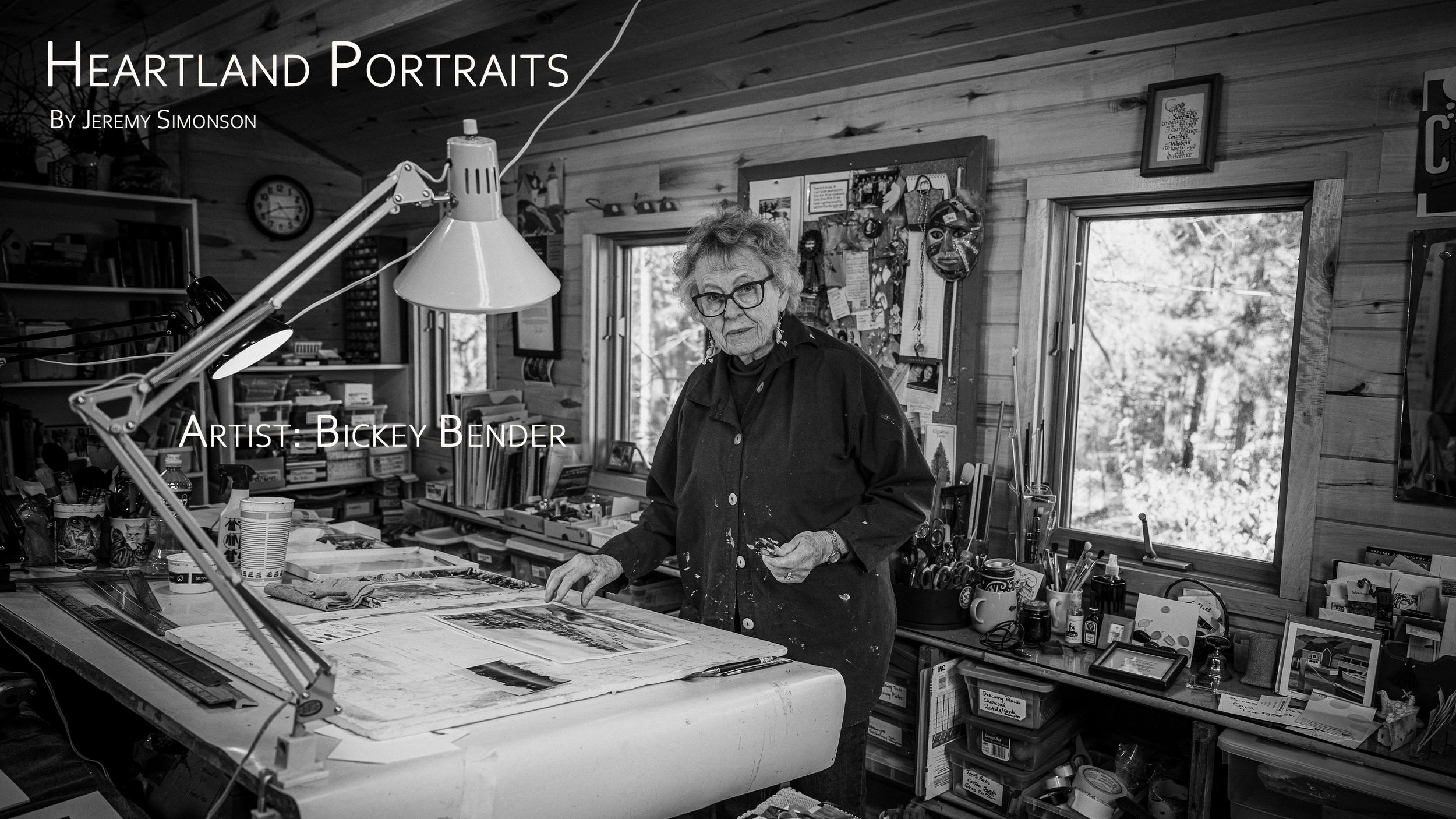 A panoramic view of a photography studio interior showing lighting equipment, props and workstations.