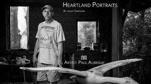 A black and white photography studio banner showing professional camera equipment and lighting setup.