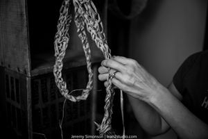 Black and white photo series showing hands interacting with metal chains in a dark atmospheric setting.