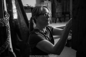A black and white photo series shows someone sitting in a car, looking out the window in different poses and angles.