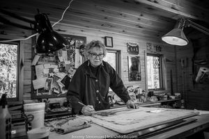 A woodworker crafts detailed pieces in a rustic workshop with various tools and equipment visible on the workbench.