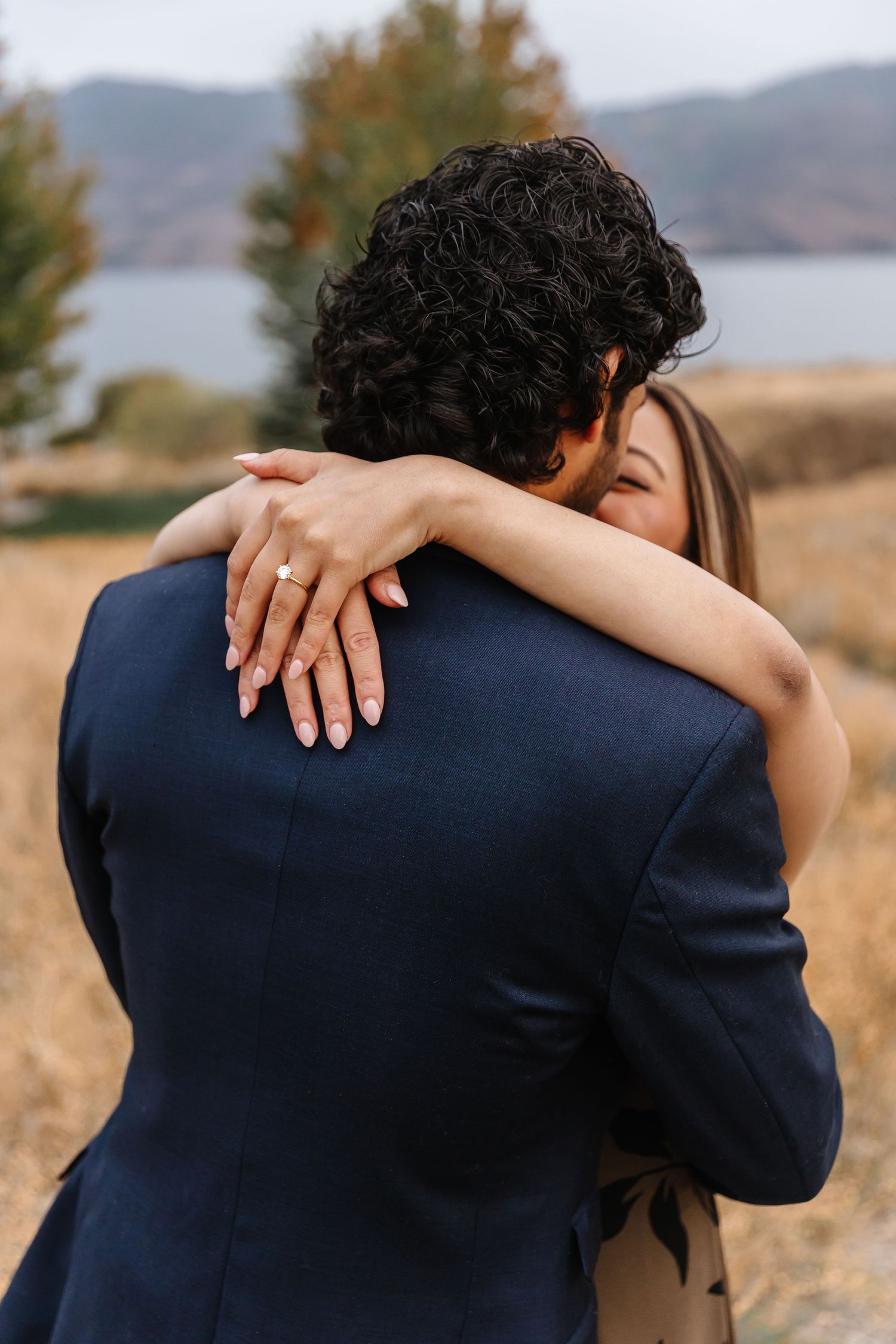 A close-up view of a couple posing for engagement photos after a surprise proposal at sanctuary gardens in West Kelowna bc