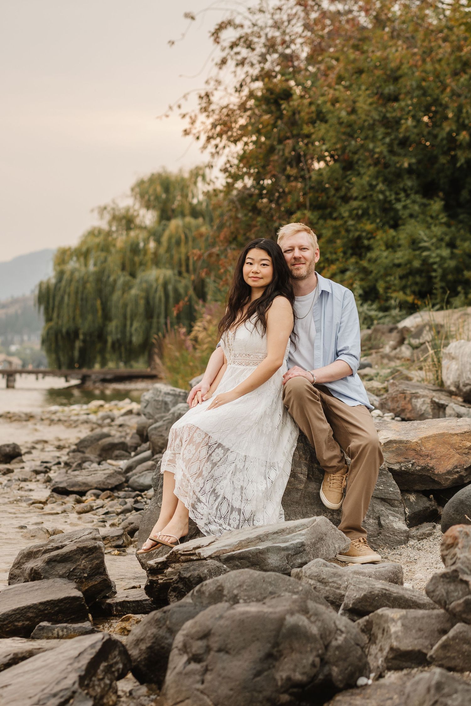 Engagement photos of a couple during golden sunset hour in West Kelowna, BC at Okanagan Lake.
