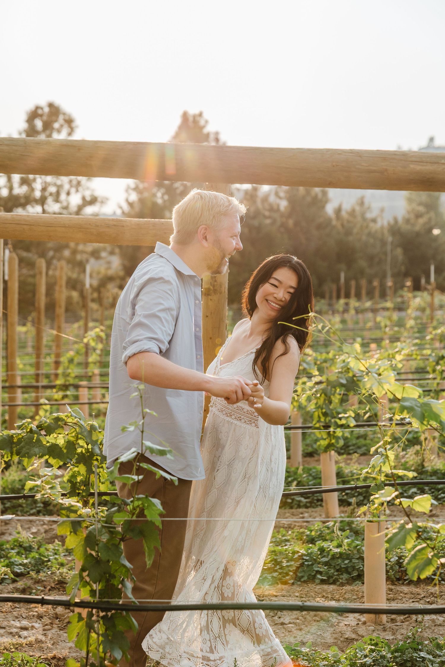 Couple dancing together in vineyard at golden hour at a West Kelowna Winery for engagement photos.