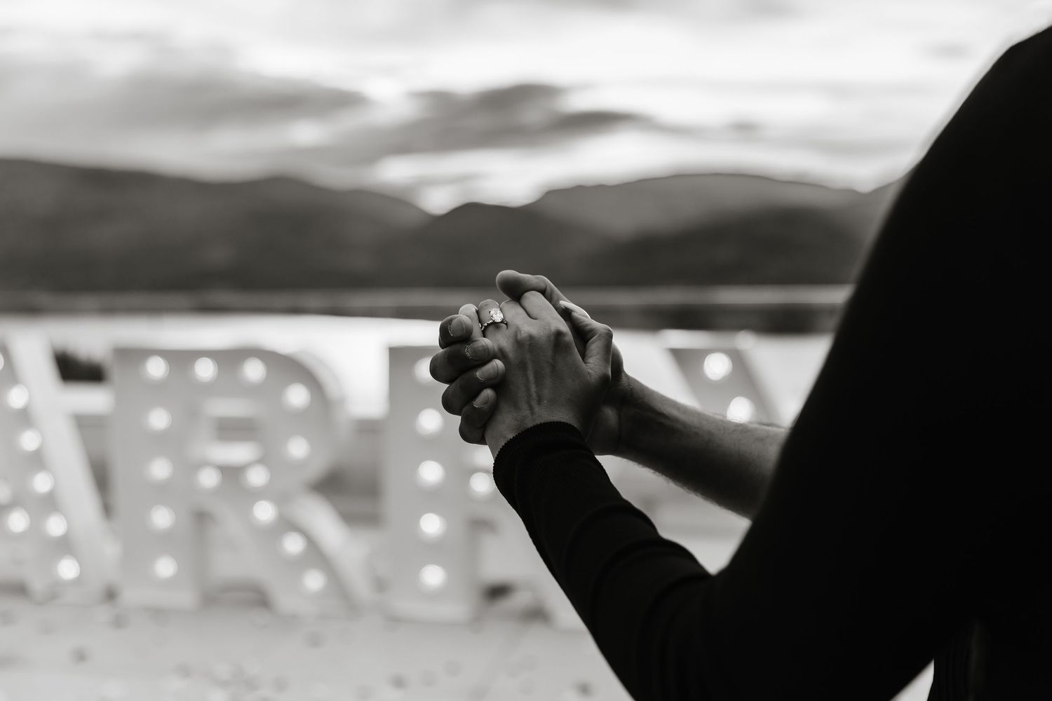 A dramatic black and white panoramic shot of engagement ring at a surprise proposal photoshoot in Kelowna bc at sparkling hills