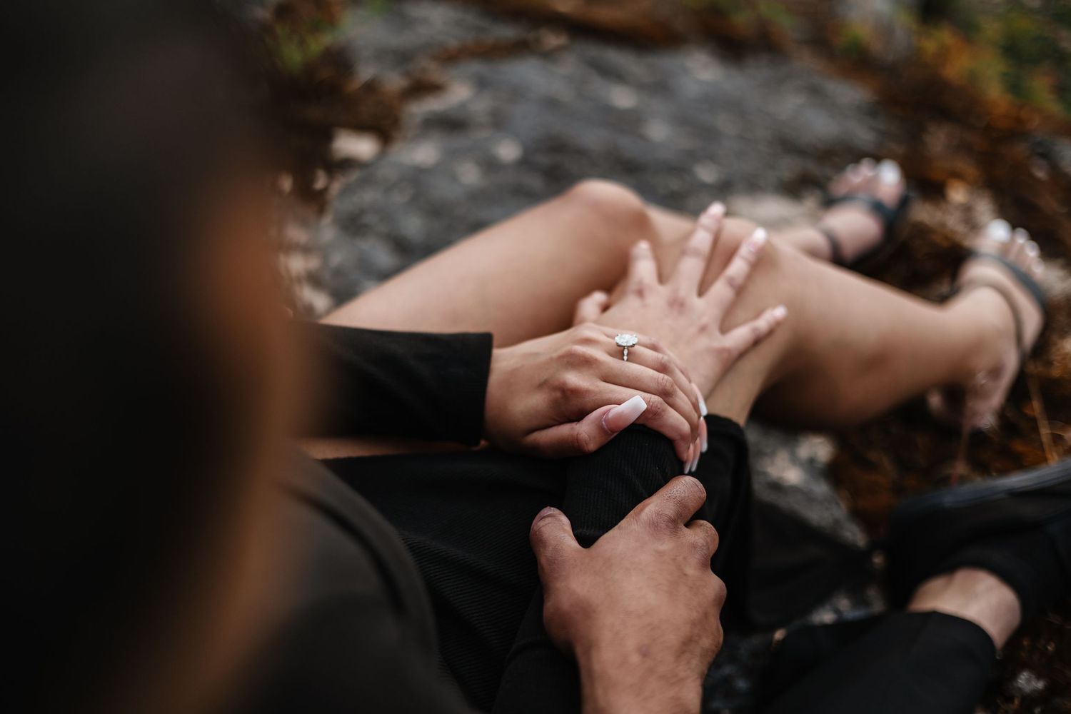 Close-up shot of hands exchanging a ring during a romantic proposal moment with Engagment ring for a photoshoot in Kelowna bc