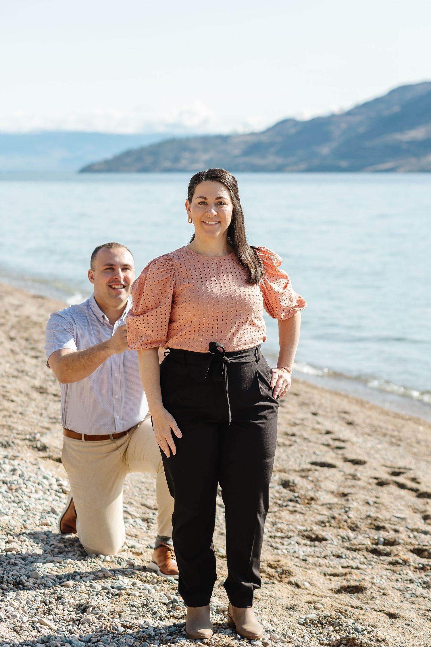 Couple surprise for proposal engagement photos with Okanagan lake in the background in Kelowna, BC.