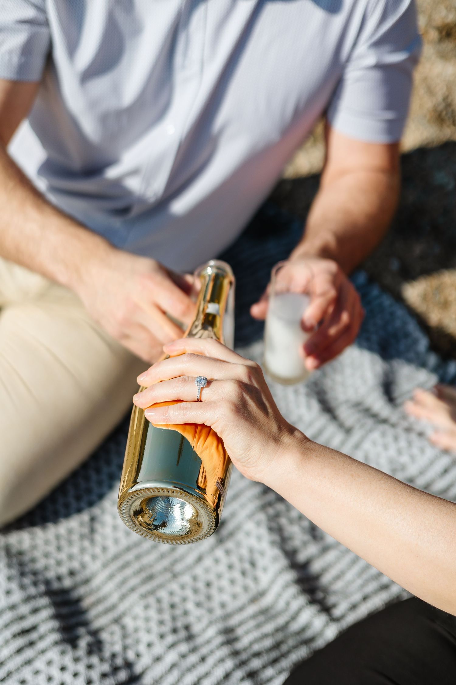 Detail shot of an engagement ring and champagne bottle during surprise proposal photoshoot in the Okanagan Valley, BC