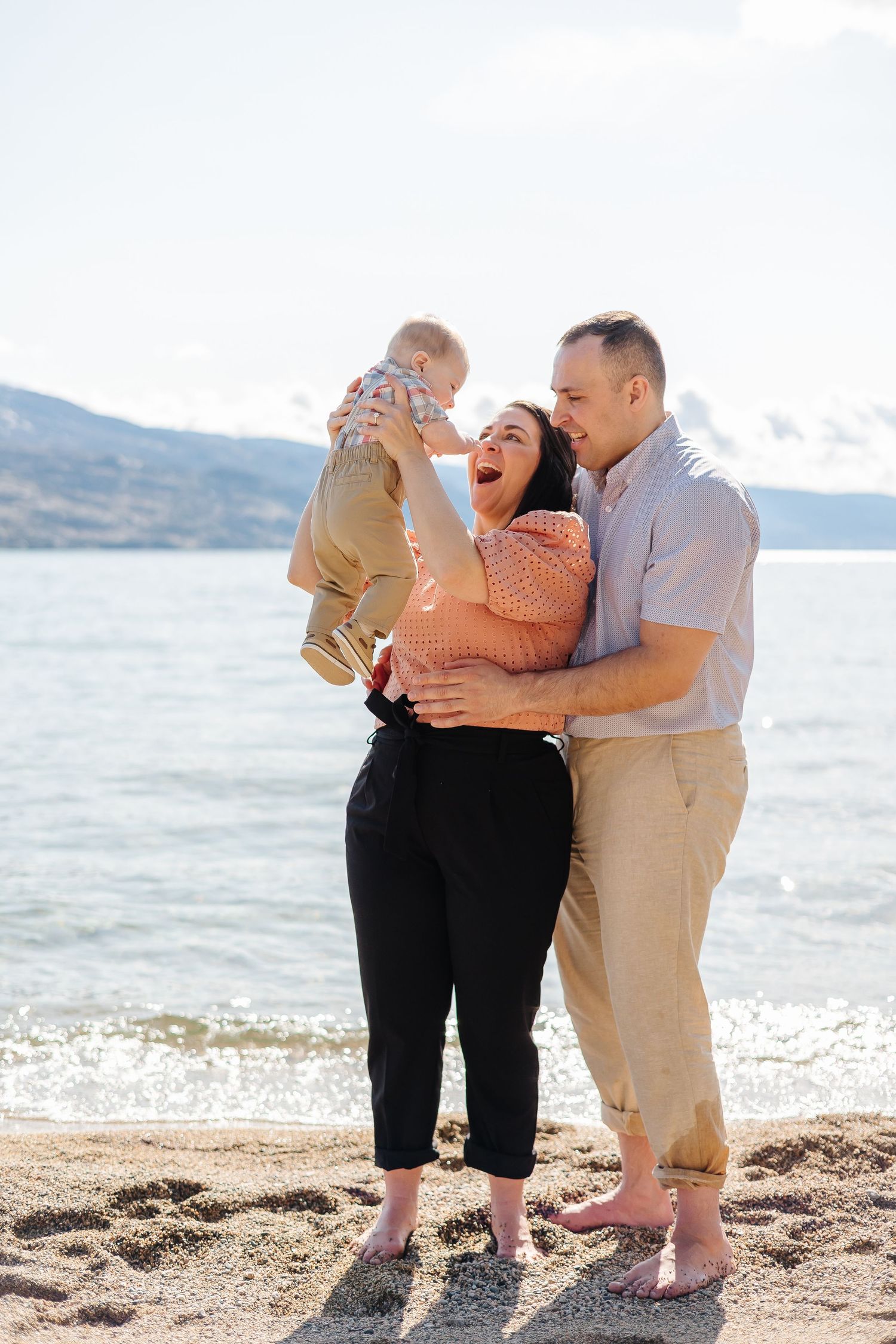 engagement photos with family at antlers beach in Peachland BC with view of the mountains and Okanagan lake in the background